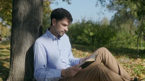 Solitude and Reflection Man Reads in the Tranquility of Nature Stock Footage 300249020