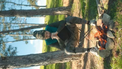Solitude and Warmth Man by a Campfire in a Forested Retreat Stock Footage 288669848