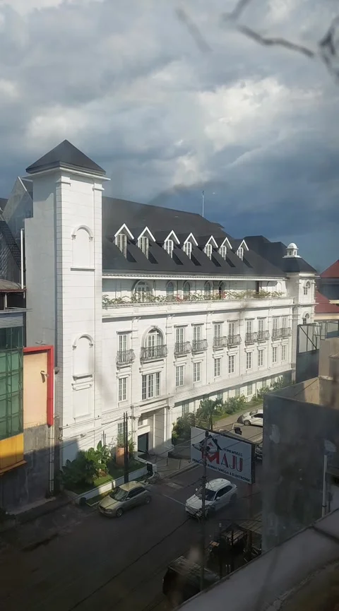 Solo, April 7, 2025: Classical Building of Hotel Mahalaya under Cloudy Sky. Stock Footage 306139043