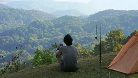 Solo freelancer man camping work outdoor and relax with layer of mountain Stock Footage 270130556