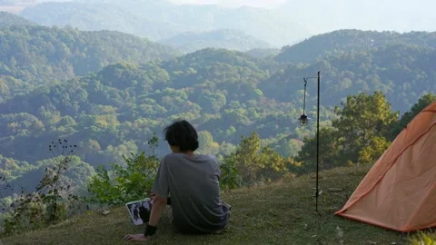 Solo freelancer man camping work outdoor and relax with layer of mountain Stock Footage 270130561