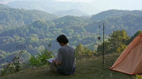 Solo freelancer man camping work outdoor and relax with layer of mountain Stock Footage 270130562