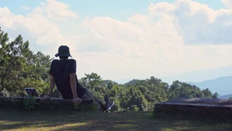 Solo freelancer man use tablet work from outdoor with layer of mountain Stock Footage 262608169