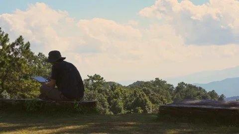 Solo freelancer man work outdoor and see layer of mountain background Stock Footage 269116076