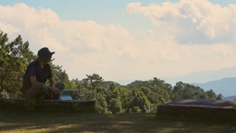 Solo freelancer man work outdoor and see layer of mountain background Stock Footage 269116077