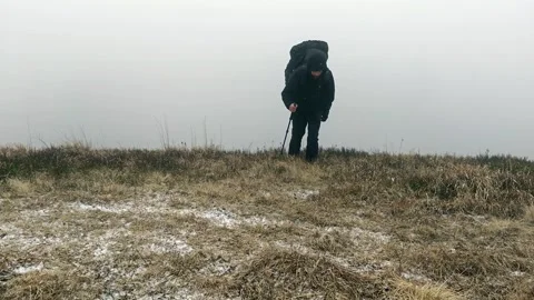 Solo Hiker with Large Backpack Walking through Heavy Mountain Fog Stock Footage 335098969