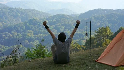 Solo man camping and work outdoor and see layer of mountain background Stock Footage 269116641