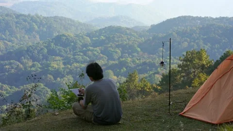 Solo man camping and work outdoor and see layer of mountain background Stock Footage 269116768