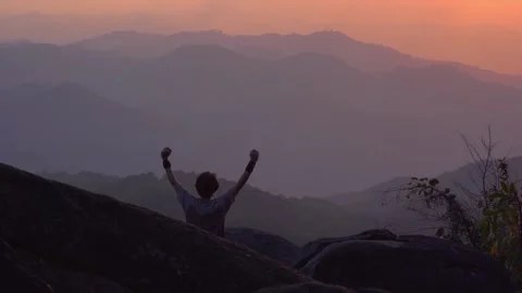 Solo man camping work outdoor and relax see sunset with layer of mountain Stock Footage 270344286