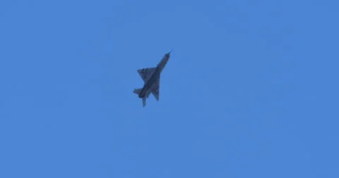 Solo MiG-21 Jet Speeding in Blue Sky - Iconic Cold War Fighter Stock Footage 270928641