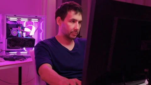 Solo software engineer working through technical issues late at night. Dedicated Stock Footage 347875128