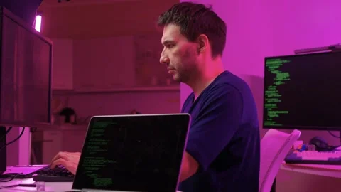 Solo software engineer working through technical issues late at night. Dedicated Stock Footage 347875148