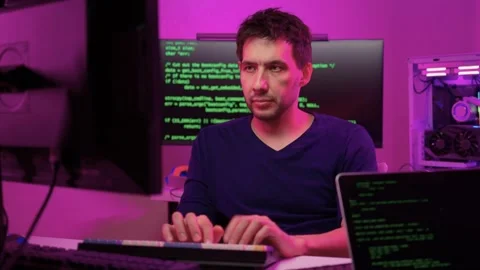Solo software engineer working through technical issues late at night. Dedicated Stock Footage 347875304