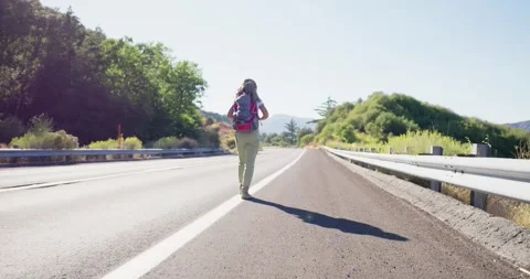 Solo Traveler Walking on Empty Highway Stock Footage 323907991