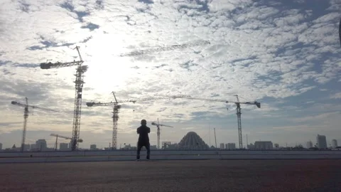 A solo workout in front of an empty construction area Stock Footage 157045505