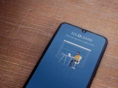SoloLearn - Learning coding app launch screen with logo on the display of a b Stock Photos