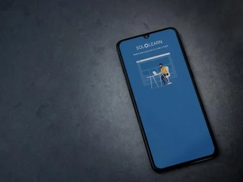 SoloLearn - Learning coding app launch screen with logo on the display of a b Stock Photos
