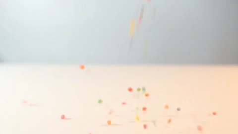 Сolorful sprinkles falling on pink background, decoration for cake and bakery Видео 138160697