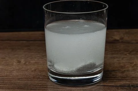 Soluble effervescent tablets dissolve in water Stock Photos