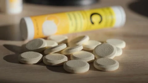 Soluble effervescent tablets of vitamin C lie on the table, close-up Stock Footage 326651493