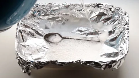 A solution of baking soda(Sodium bicarbonate) and warm water reaction. Video stock 166065853