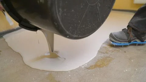 The solution bulk floor is poured from a basin onto the floor Stock Photos