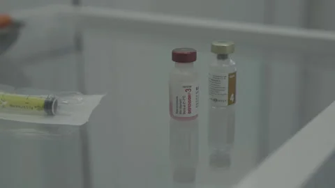 Solution for injections. Bottles with solution on the table Stock Footage 247707094