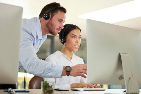The solution is on its way. a young man and woman using a computer while working Foto stock