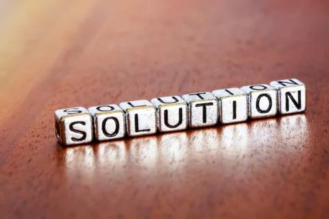 Solution letters placed on a desk in precious wood Stock Photos