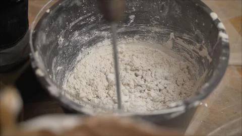 The solution is mixed with a construction mixer. Mix the solution in a bucket Stock Photos