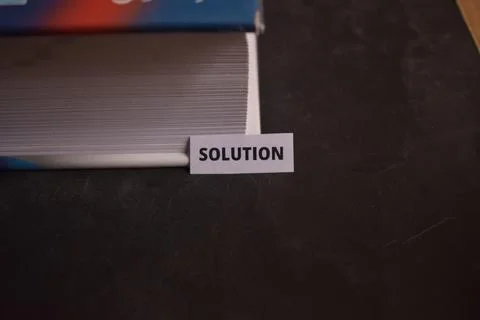 Solution Paper Tab Inserted in Book Pages Symbolizing Answers and Clarity 库存照片