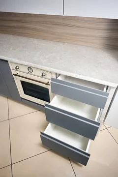 Solution for placing kitchen utensils in modern kitchen. Horizontal sliding Stock Photos