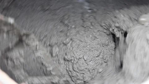 The solution is spinning in a large container. Mixing concrete in a concrete mix Stock Footage 152592143