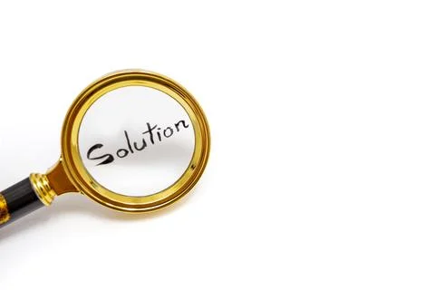 Solution word hand written with black ink, under a golden magnifying glass,.. Stock Photos