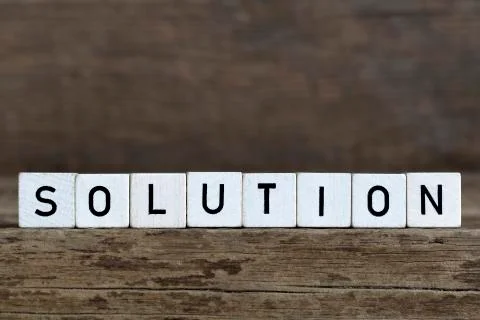 Solution, written in cubes on wooden background Stock Photos