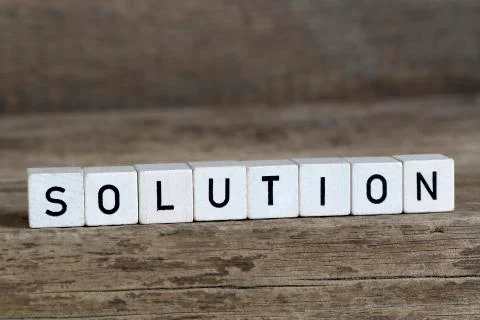 Solution, written in cubes on wooden background Stock Photos