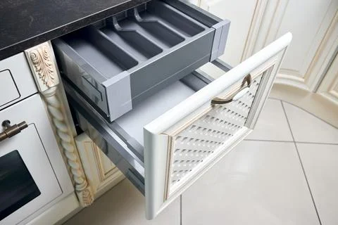 Solutions for placing utensils in classic kitchen - horizontal sliding pull out Stock Photos