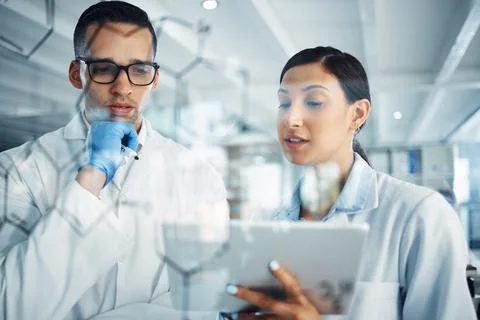The solve anything team. Shot two a young scientists solving equations on a Stock Photos