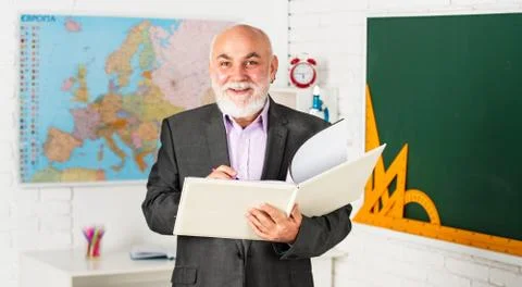 Solve complex problem. teacher of geography. classroom with map and blackboard Stock Photos