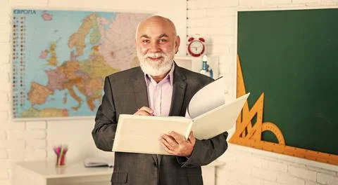 Solve complex problem. teacher of geography. classroom with map and blackboard Stock Photos
