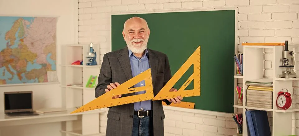 Solve mathematical problems. mature man teacher use math triangle tool. bearded Stock Photos