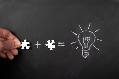 Solve puzzle combining the wisdom for developing new idea, drawing light bulb on Stock Photos