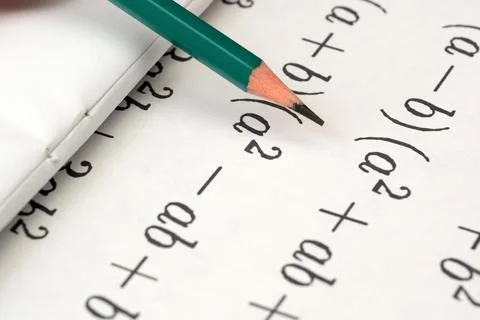 Solving algebraic equations with a pencil on notebook paper 스톡 사진