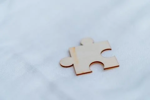 Solving business challenges a single puzzle piece on white background abstract Stock Photos
