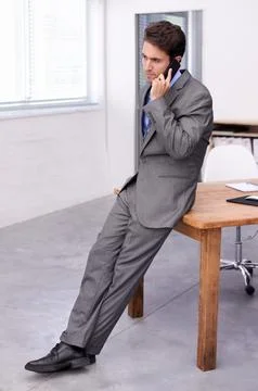 Solving business problems via cellphone. A young businessman busy on an Stock Photos