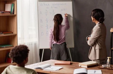 Solving math problem at lesson Stock Photos