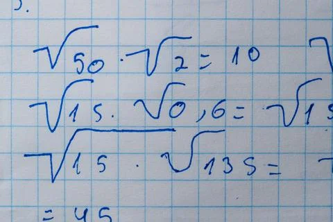 Solving mathematical puzzles on squared paper in a study nook Stock Photos