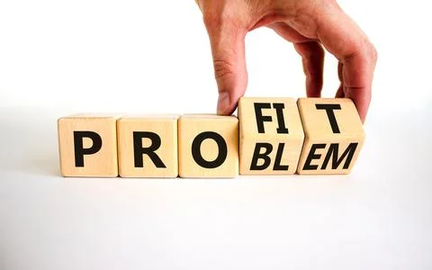 Solving a problem and making profit symbol. Businessman turns wooden cubes, c Stock Photos
