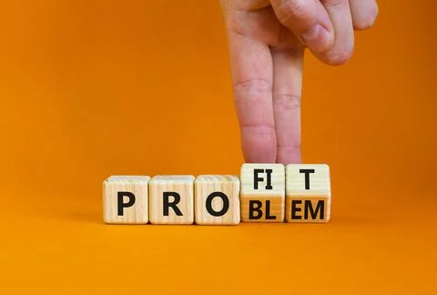 Solving a problem and making profit symbol. Businessman turns wooden cubes, c Stock Photos