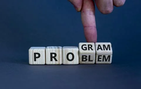 Solving a problem and making program symbol. Businessman turns wooden cubes a Stock Photos